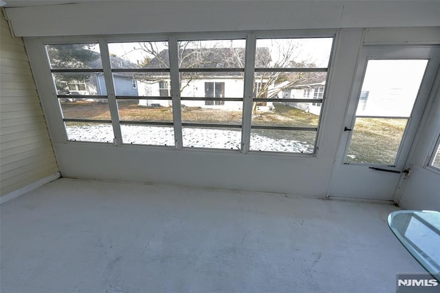 unfurnished sunroom featuring plenty of natural light