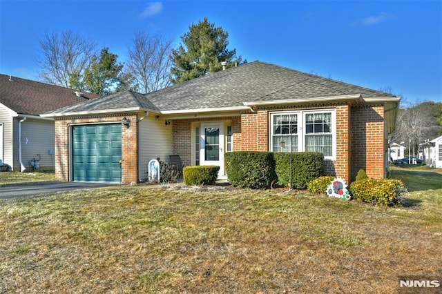 single story home featuring a garage and a front yard