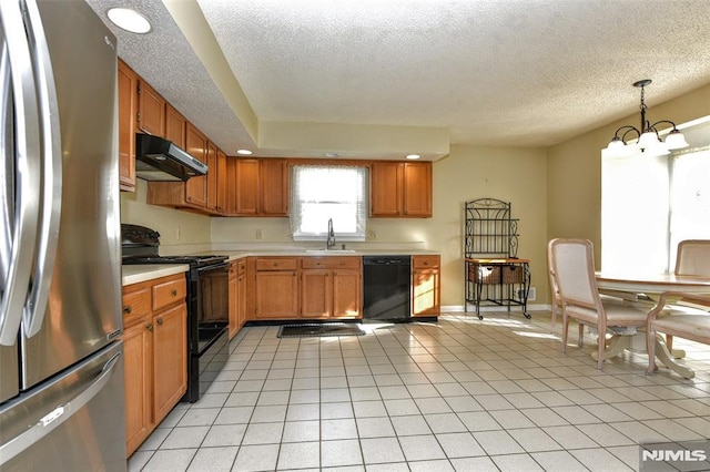 kitchen with a notable chandelier, pendant lighting, black appliances, sink, and light tile patterned flooring