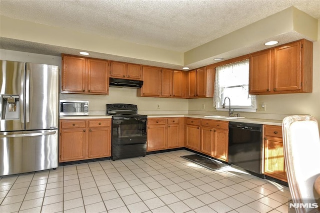 kitchen featuring sink, a textured ceiling, light tile patterned floors, and black appliances