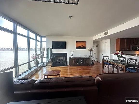 living room featuring wood-type flooring and expansive windows