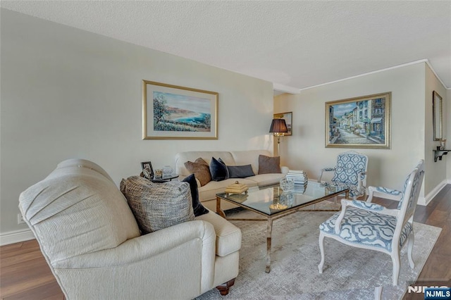 living room featuring hardwood / wood-style flooring and a textured ceiling