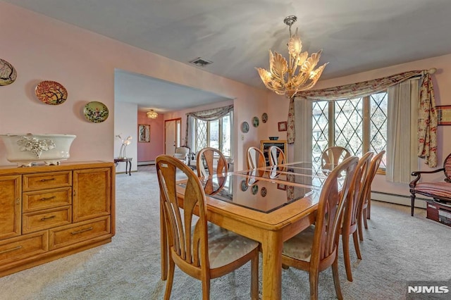 carpeted dining area featuring a wealth of natural light, a baseboard heating unit, and a notable chandelier