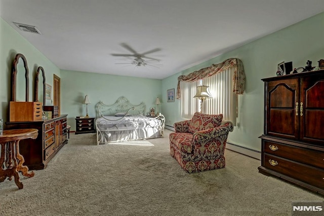 carpeted bedroom with ceiling fan and a baseboard heating unit