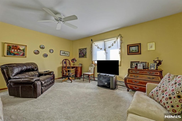 carpeted living room with a baseboard heating unit and ceiling fan