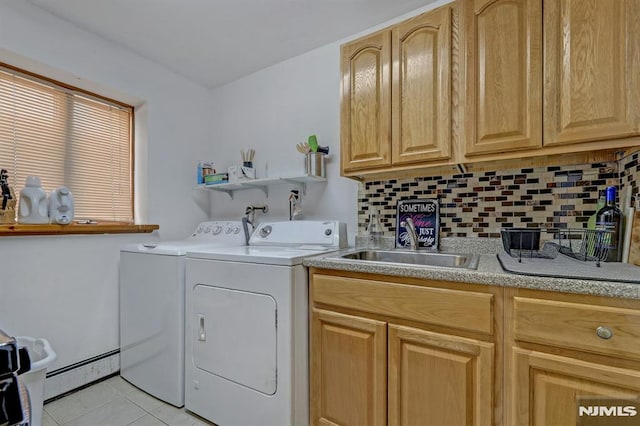 clothes washing area featuring light tile patterned floors, a baseboard heating unit, sink, and separate washer and dryer