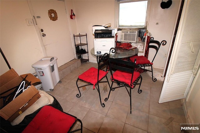 dining space featuring cooling unit and light tile patterned flooring