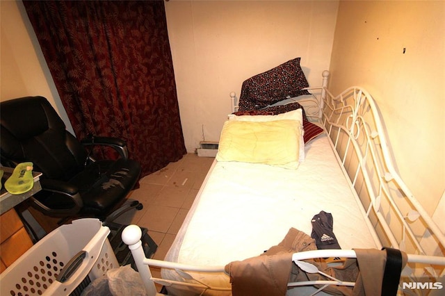 bedroom with light tile patterned floors