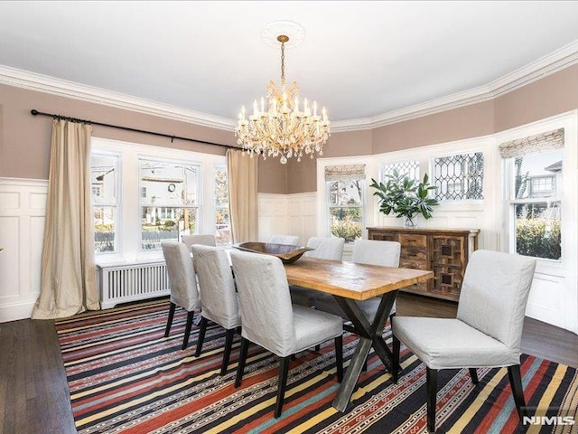 dining area with ornamental molding, a chandelier, dark hardwood / wood-style floors, and radiator heating unit