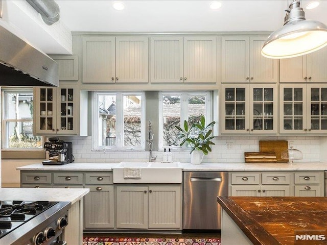 kitchen with pendant lighting, dishwasher, extractor fan, sink, and gray cabinetry