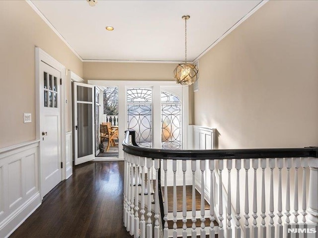 hall with ornamental molding and dark hardwood / wood-style floors