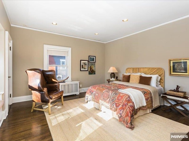 bedroom featuring wood-type flooring, radiator, and crown molding