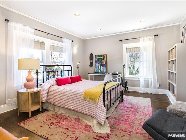 bedroom featuring dark hardwood / wood-style floors, crown molding, and multiple windows