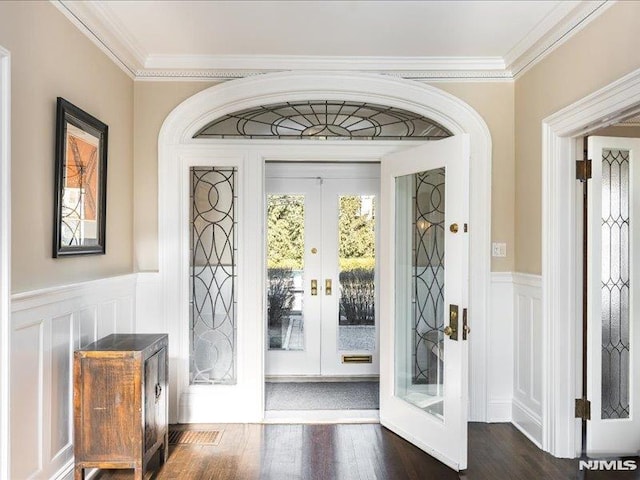 interior space with dark hardwood / wood-style floors, crown molding, and french doors