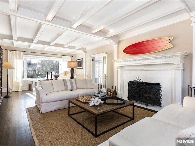 living room with a fireplace, beamed ceiling, and hardwood / wood-style flooring