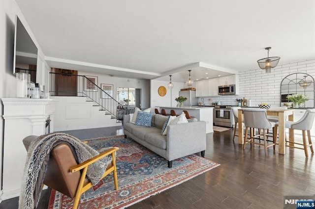 living room with dark wood-type flooring and sink