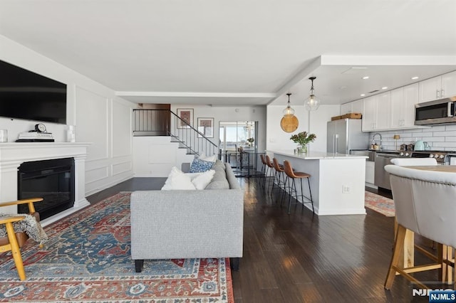 living room featuring dark wood-type flooring