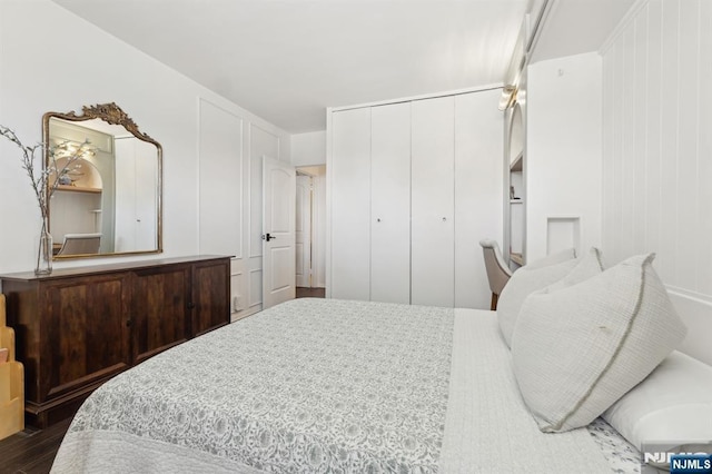 bedroom featuring dark hardwood / wood-style floors and a closet