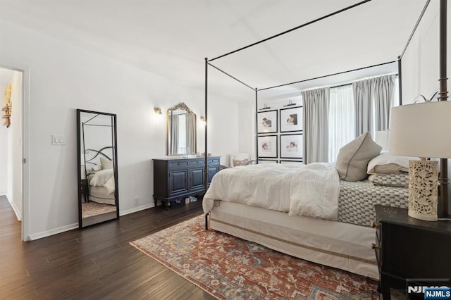 bedroom with dark hardwood / wood-style flooring