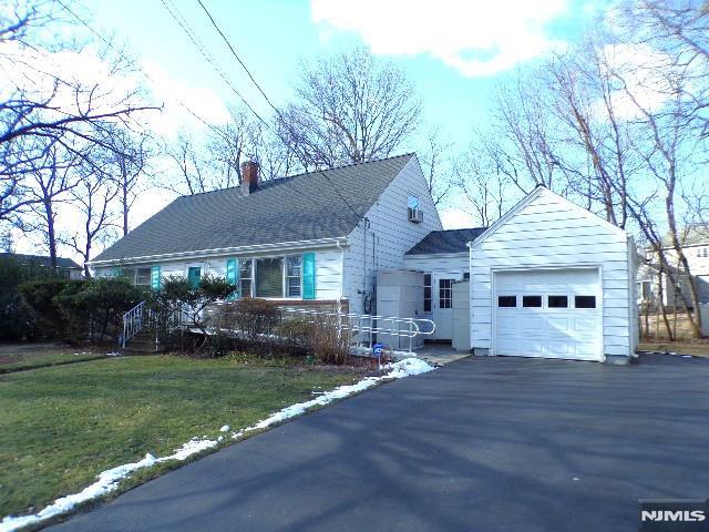 view of front of property with a front lawn and a garage