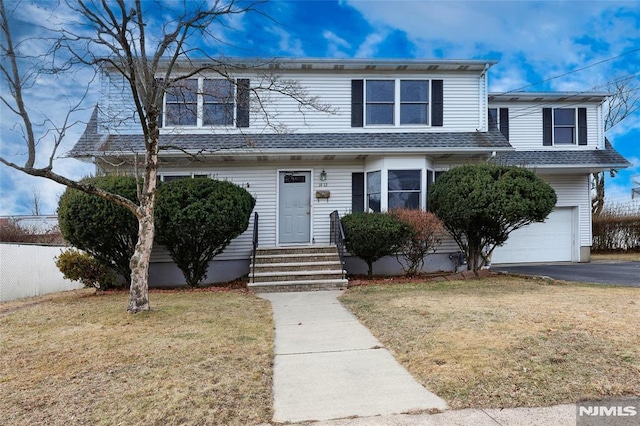 view of front of house with a garage and a front yard