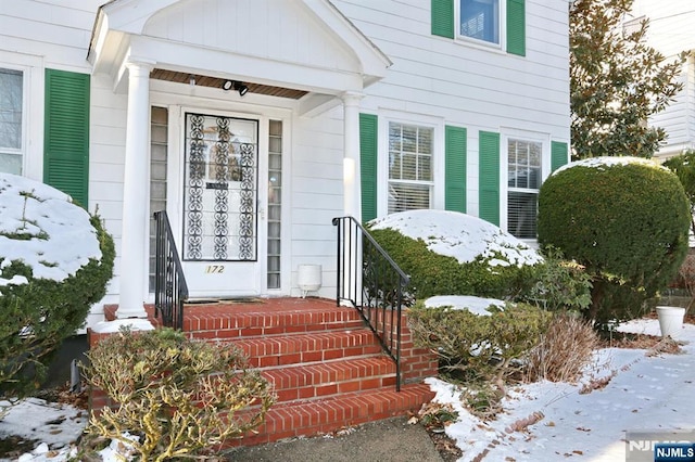 view of snow covered property entrance