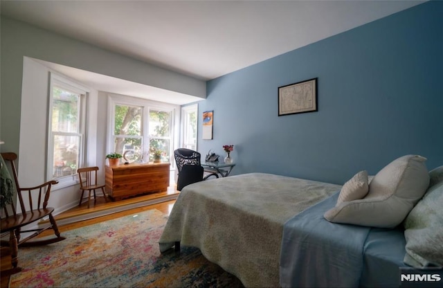 bedroom with hardwood / wood-style flooring