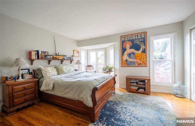 bedroom with wood-type flooring