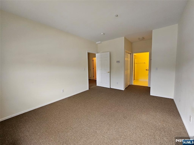 unfurnished bedroom featuring dark carpet