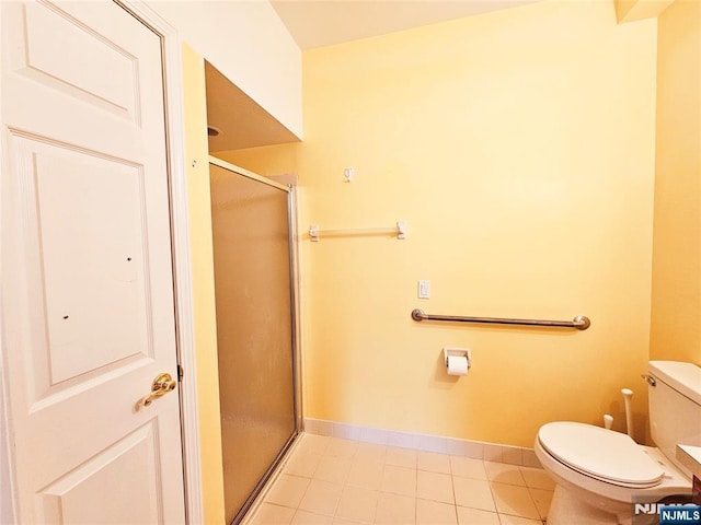 bathroom with tile patterned floors, toilet, and walk in shower