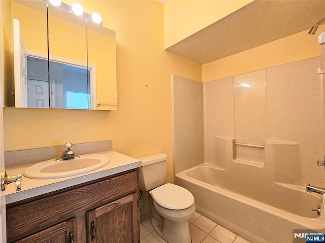 full bathroom featuring toilet, vanity, tile patterned floors, and shower / tub combination