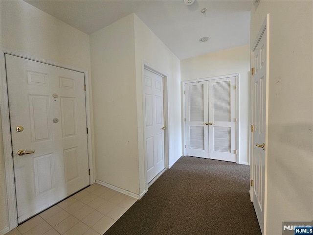 hall featuring light colored carpet