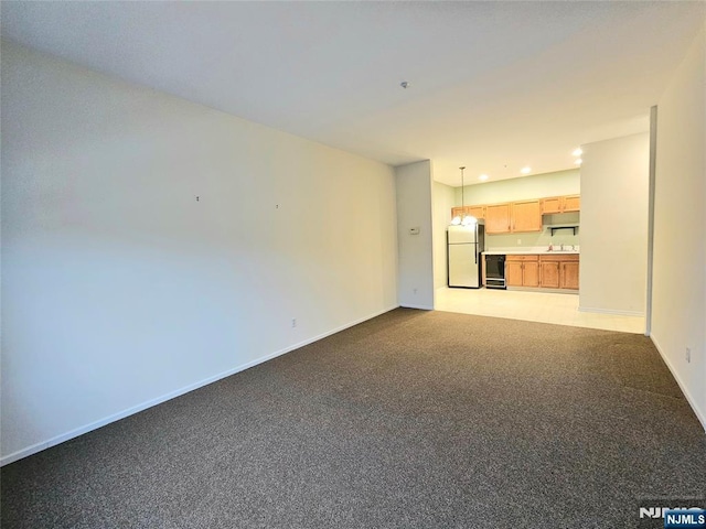 unfurnished living room with carpet