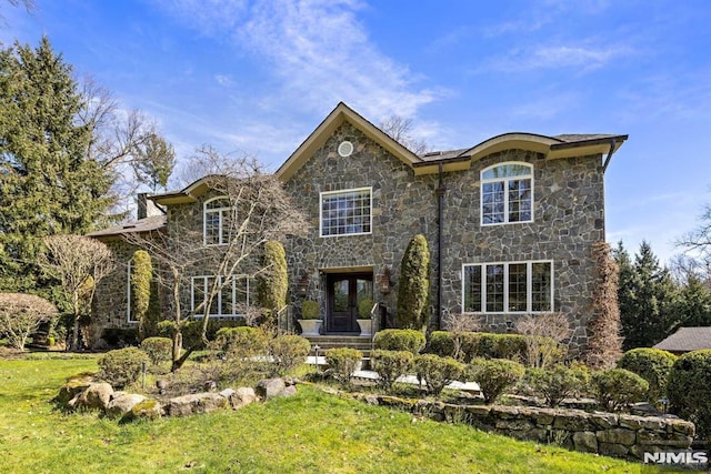 view of front facade featuring a front lawn and french doors