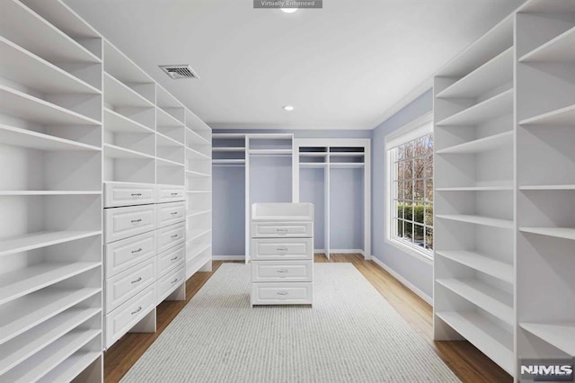 walk in closet featuring dark hardwood / wood-style floors