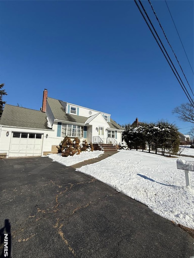 cape cod house featuring a garage