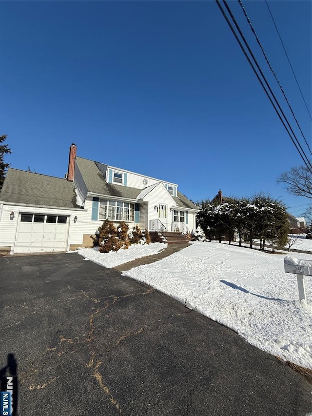 cape cod house with a garage