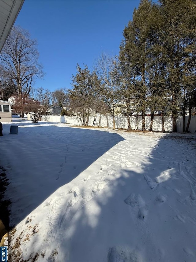 view of yard layered in snow