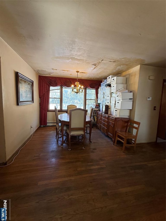 dining space with an inviting chandelier, dark hardwood / wood-style floors, and baseboard heating