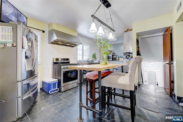 120 Prospect Ave, Hackensack, NJ 07601 - kitchen with wall chimney exhaust hood, stainless steel appliances, butcher block countertops, and hanging light fixtures