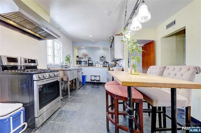 120 Prospect Ave, Hackensack, NJ 07601 - kitchen featuring stainless steel gas stove, hanging light fixtures, and range hood