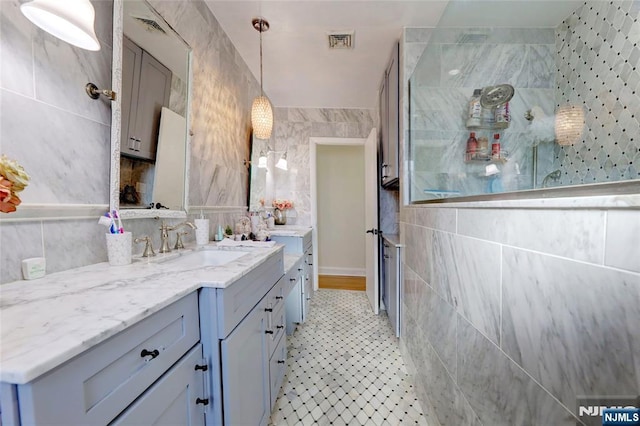 120 Prospect Ave, Hackensack, NJ 07601 - bathroom featuring a shower, tile walls, and vanity