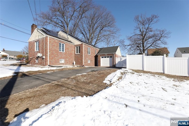 120 Prospect Ave, Hackensack, NJ 07601 - snow covered property featuring an outbuilding and a garage