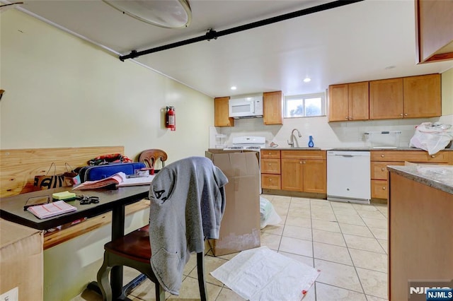 120 Prospect Ave, Hackensack, NJ 07601 - kitchen with tasteful backsplash, sink, light tile patterned floors, and white appliances