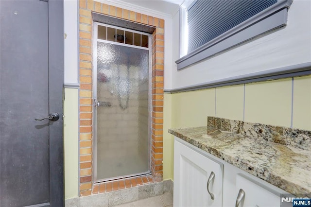120 Prospect Ave, Hackensack, NJ 07601 - bathroom with vanity, tile patterned floors, ornamental molding, and walk in shower