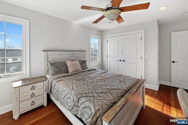 bedroom featuring a ceiling fan, baseboards, recessed lighting, dark wood-style flooring, and a closet