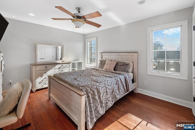 bedroom featuring recessed lighting, baseboards, multiple windows, and hardwood / wood-style flooring