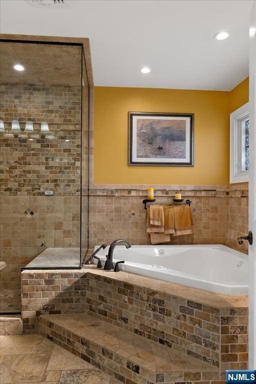 full bathroom with a garden tub, recessed lighting, and a tile shower