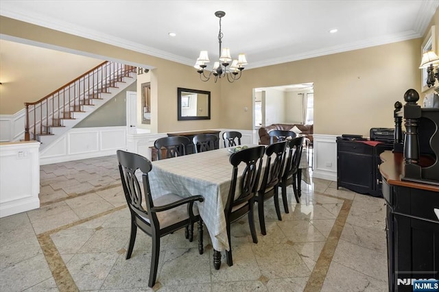 dining area featuring a wainscoted wall, recessed lighting, stairway, an inviting chandelier, and crown molding