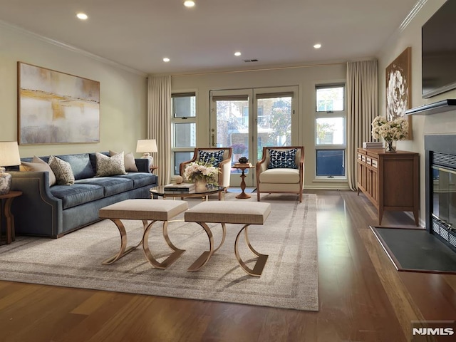 living room featuring dark hardwood / wood-style floors and crown molding